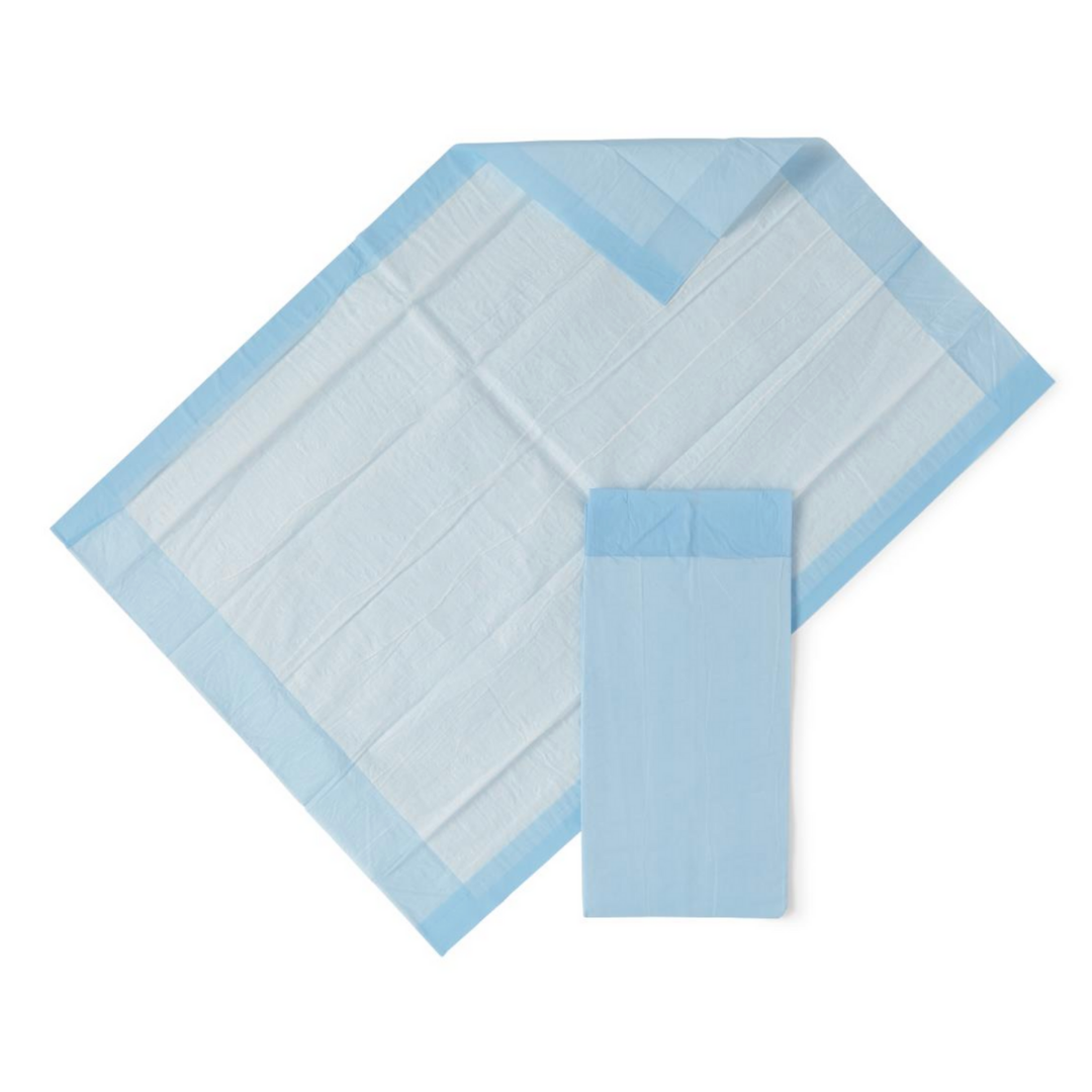 A Medline Protection Plus Disposable Underpad in blue and white, known for excellent absorbency, is spread out on a white background with another underpad folded neatly beside it.